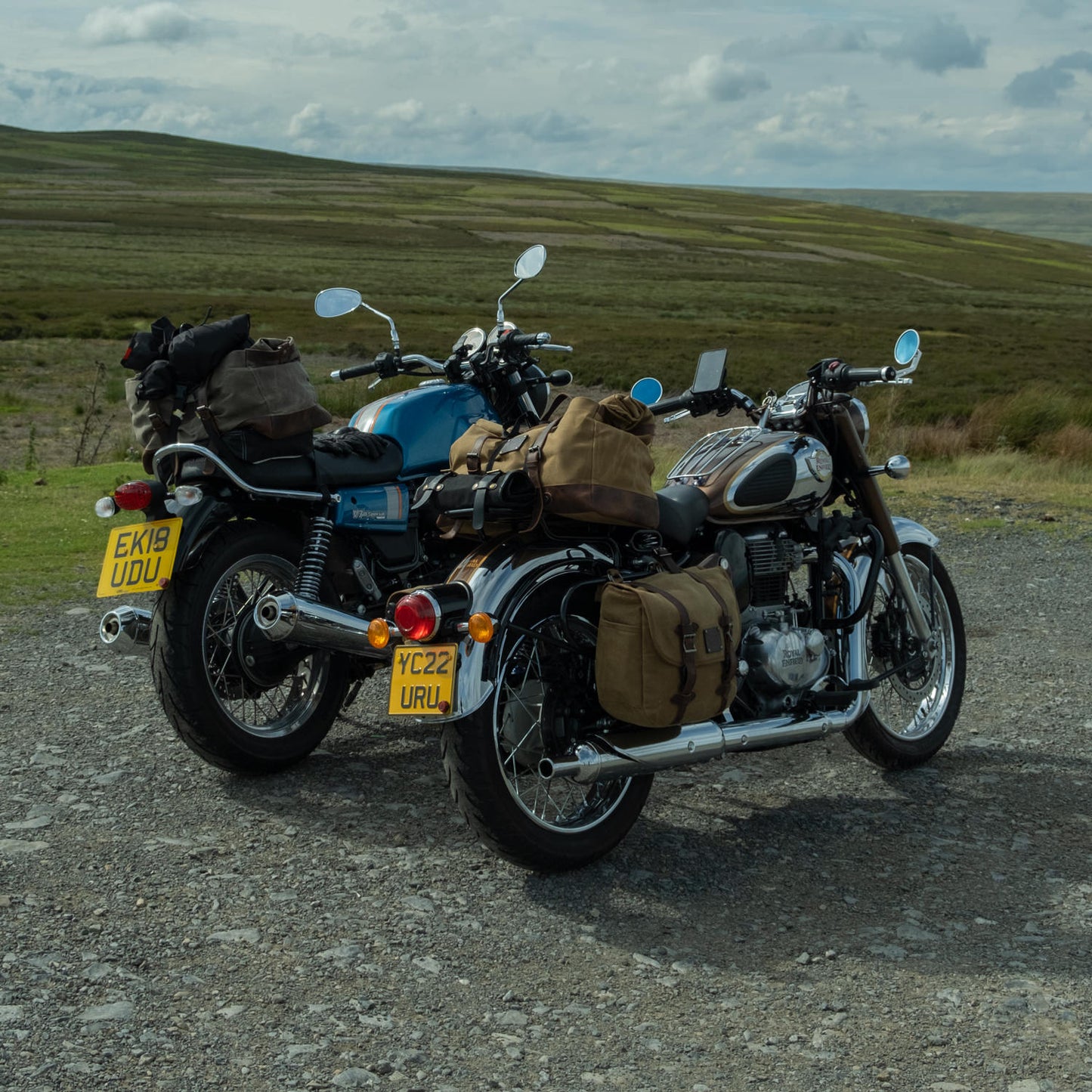 Two modern classic motorcycle with canvas panniers and tail bags