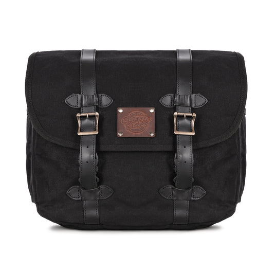 A black waxed canvas motorcycle pannier bag with side release buckles and a detachable shoulder strap.