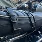 Close-up of motorcycle saddlebag mounting leather straps in black.
